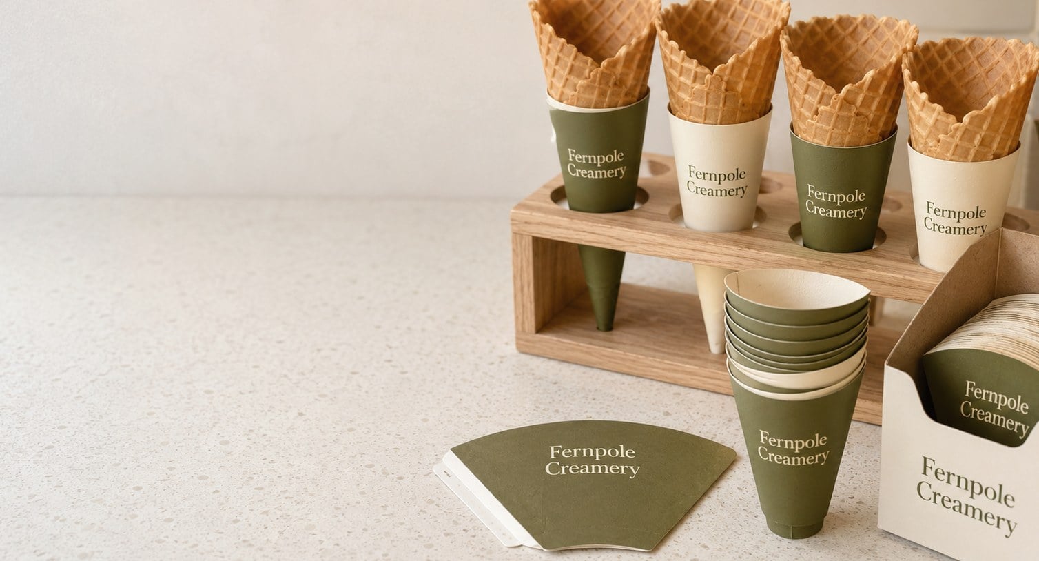 Custom printed cone sleeves on empty wafer cones in a rack with a flat arc die-cut